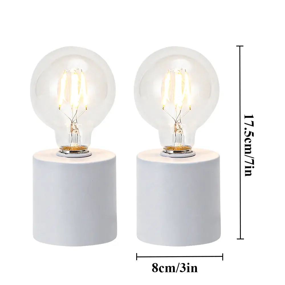 Set of 2 white battery-powered table lamps with clear bulbs on white cylindrical bases by JHY DESIGN