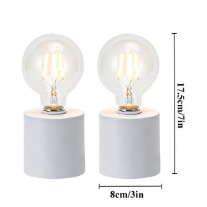 Set of 2 white battery-powered table lamps with clear bulbs on white cylindrical bases by JHY DESIGN