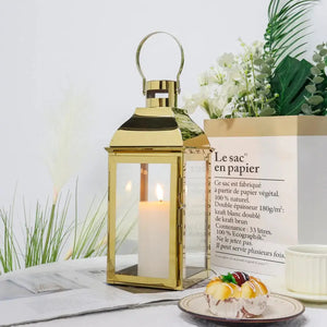 12.5-inch gold stainless steel decorative candle lantern with glass panels and top handle.