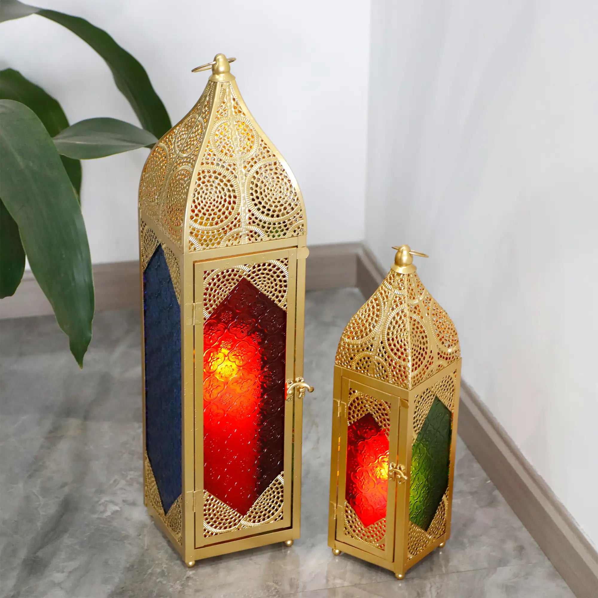 Set of 2 Moroccan candle lanterns; gold-tone metal with intricate lattice and red/green glass panels