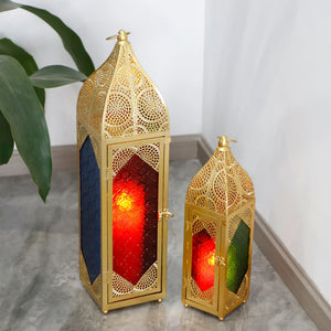 Set of 2 Moroccan candle lanterns; gold-tone metal with intricate lattice and red/green glass panels