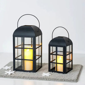 Set of 2 black metal candle lanterns with glass panes, 10.5-inch and 14-inch tall.