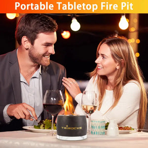 Black graphite color cement concrete portable tabletop fireplace by TRIROCKS on a dinner table with wine glasses.