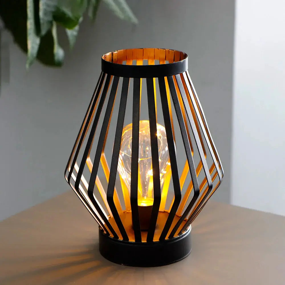 8.7in tall battery-powered table lamp Diamond, black geometric metal cage around a warm glowing bulb
