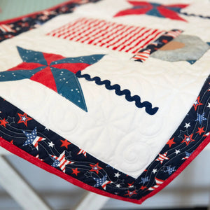Quilt kit: Patriotic Gnomes Quilted Table Runner with red, white, and blue star and stripe fabrics