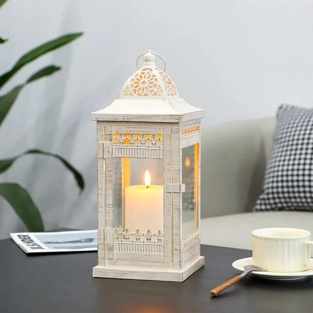Decorative candle lantern, beige with gold-brushed accents, vintage metal, lit candle inside