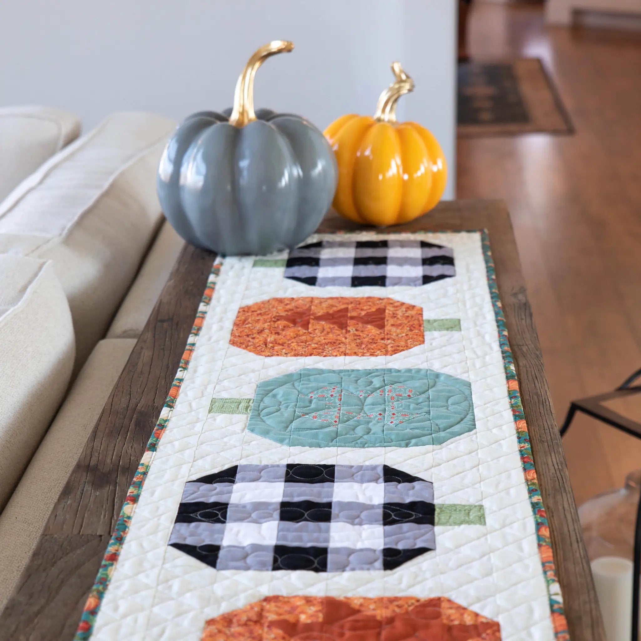Quilt Kit: Pumpkin Patchwork Quilted Table Runner with two blue-gray and orange pumpkins.