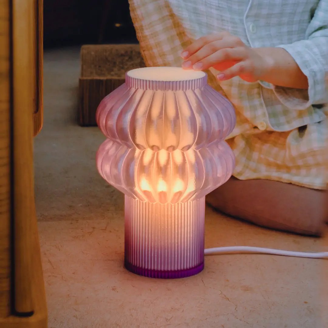Oppi Table Lamp by Terra Labs; purple ribbed glass with warm amber glow