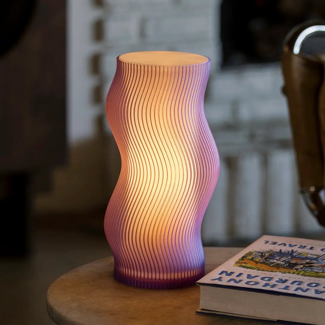 Woogie Table Lamp by Terra Labs; curved ribbed glass lamp with pink-purple gradient glow.