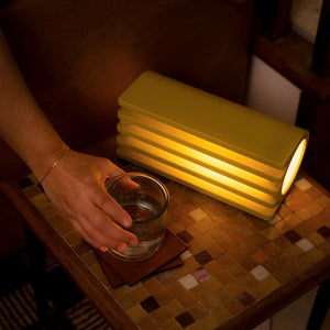 Radiator Table Lamp by Terra Labs; yellow stacked ribbed design emitting warm light