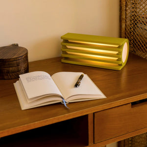Radiator table lamp by Terra Labs in lime green with a slatted radiator-style design.