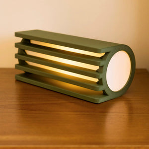 Terra Labs Radiator Table Lamp with a green slatted metal frame and white circular shade.