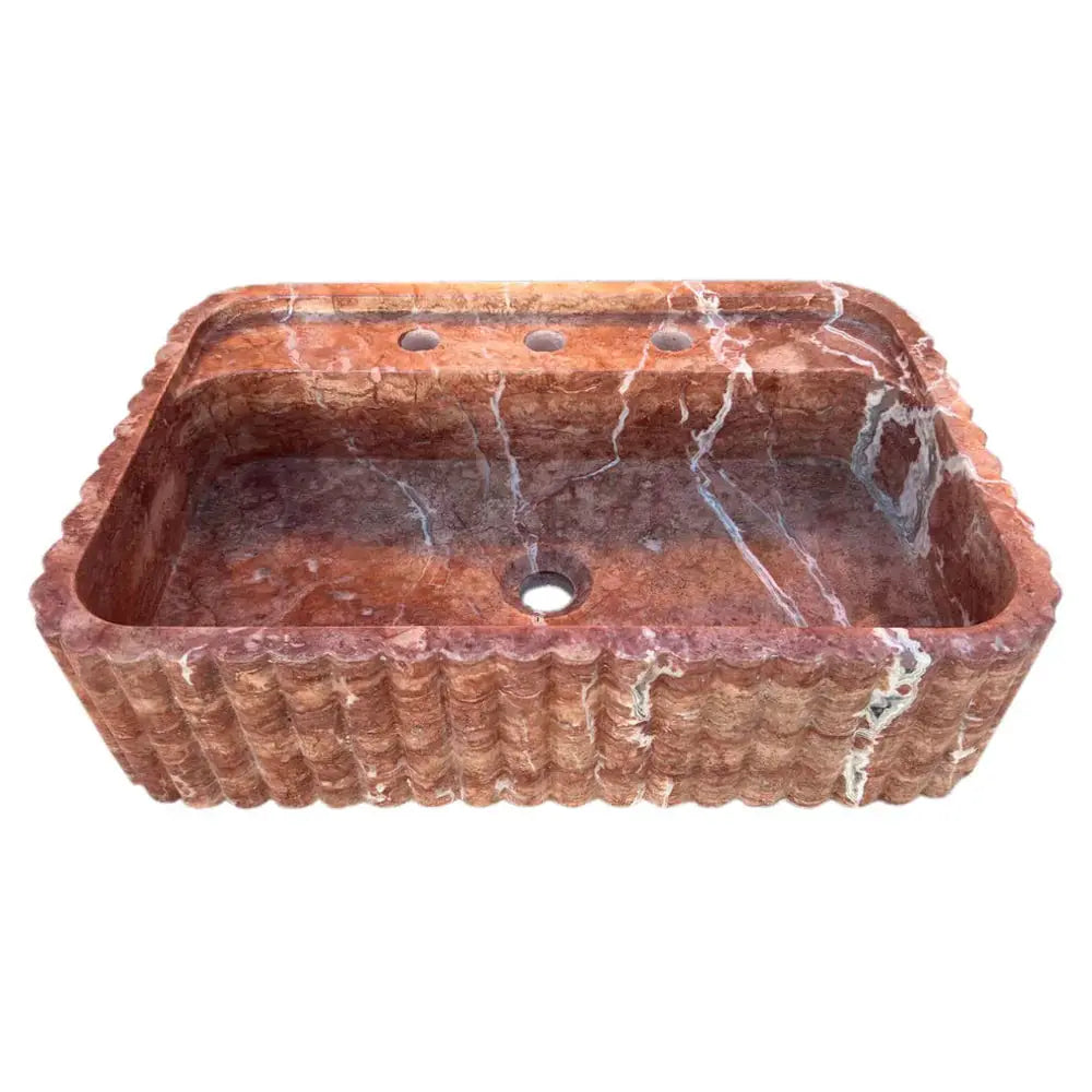 Red travertine wall-mount bathroom sink by Villohome; ribbed textured exterior, rectangular basin.