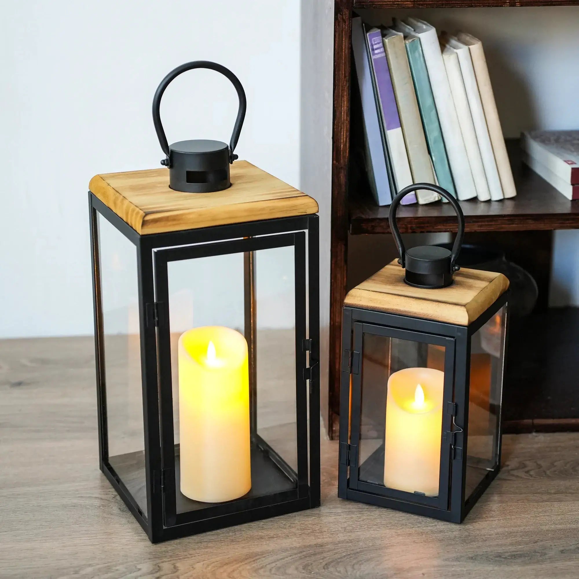 Set of 2 JHY DESIGN decorative candle lanterns, 16in and 11in, black metal frames with glass panels.
