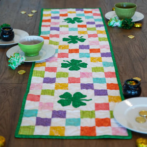 Quilt Kit: Shamrocks Rainbow Table Runner in rainbow blocks with green border by Block Party Quilt Co