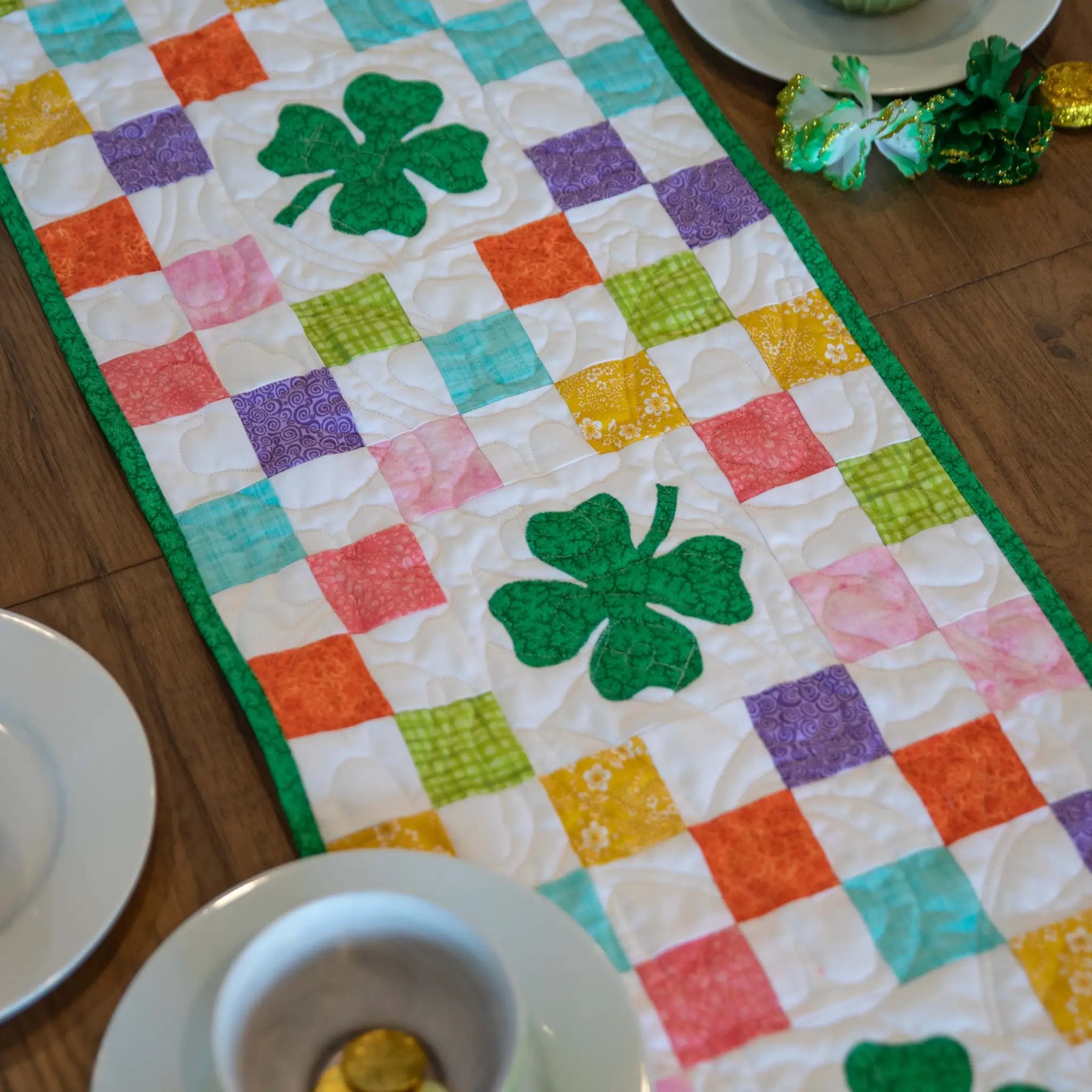 Shamrocks Rainbow Table Runner Quilt Kit by Block Party Quilt Co; rainbow patchwork with green shamrock centerpiece