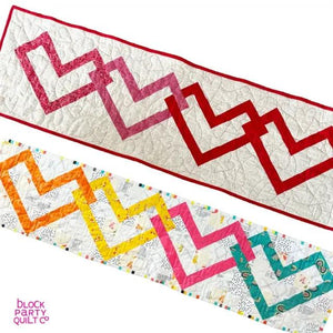 Linked Hearts Quilted Table Runner Kit by Block Party Quilt Co; two colorful zigzag heart runners.