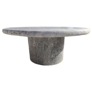 Round coffee table with a silver travertine vein-cut honed top on a cylindrical pedestal.