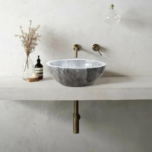 Sirius Gray Marble Vessel bathroom sink by Villohome on a white countertop with brass wall-mounted faucet