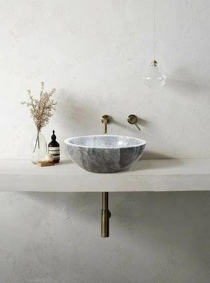 Sirius Gray Marble Vessel Sink by Villohome on a white vanity with brass wall faucet