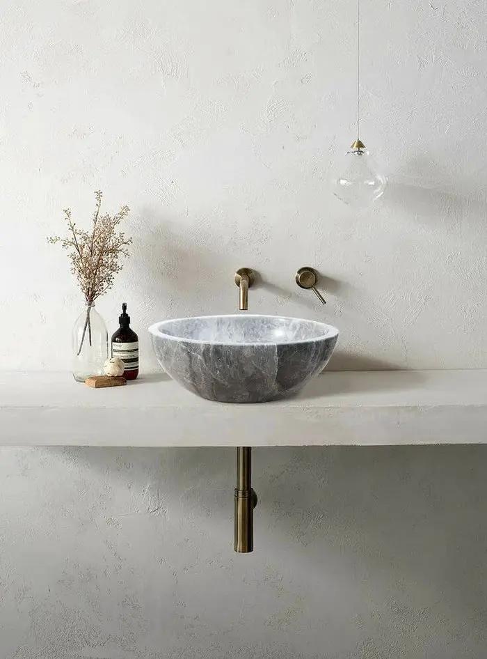 Sirius Gray Marble Vessel Sink by Villohome on a white vanity with brass wall faucet