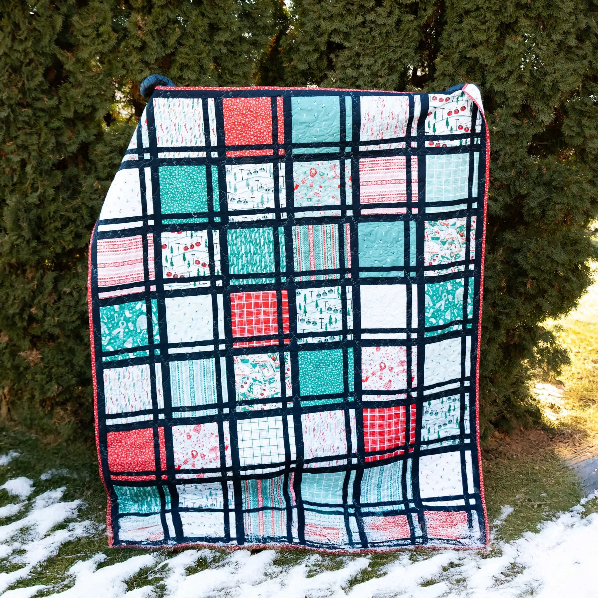 Plaidy Cakes 10-inch quilt pattern by Block Party Quilt Co, patchwork with navy sashing and red teal white blocks