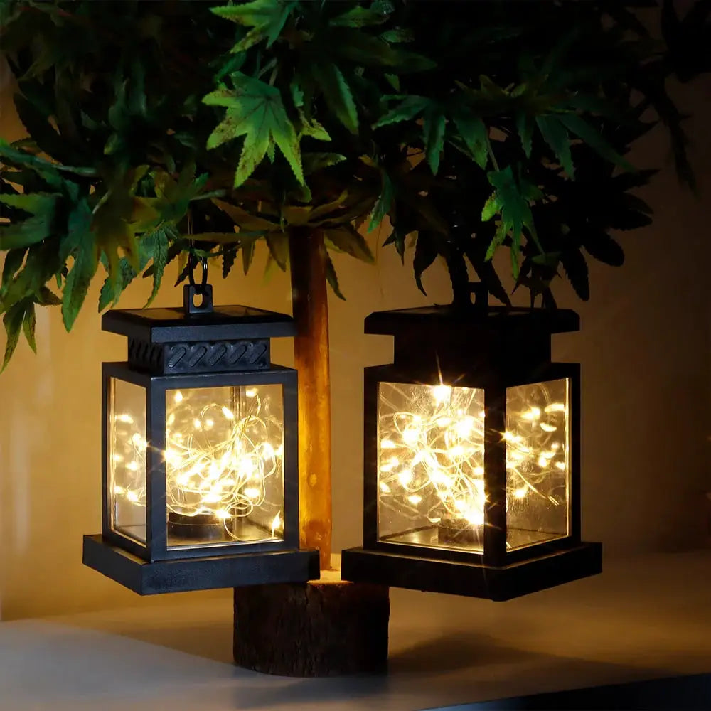 Set of 2 solar lantern lights by JHY DESIGN, black metal frames with glass panels and warm string lights