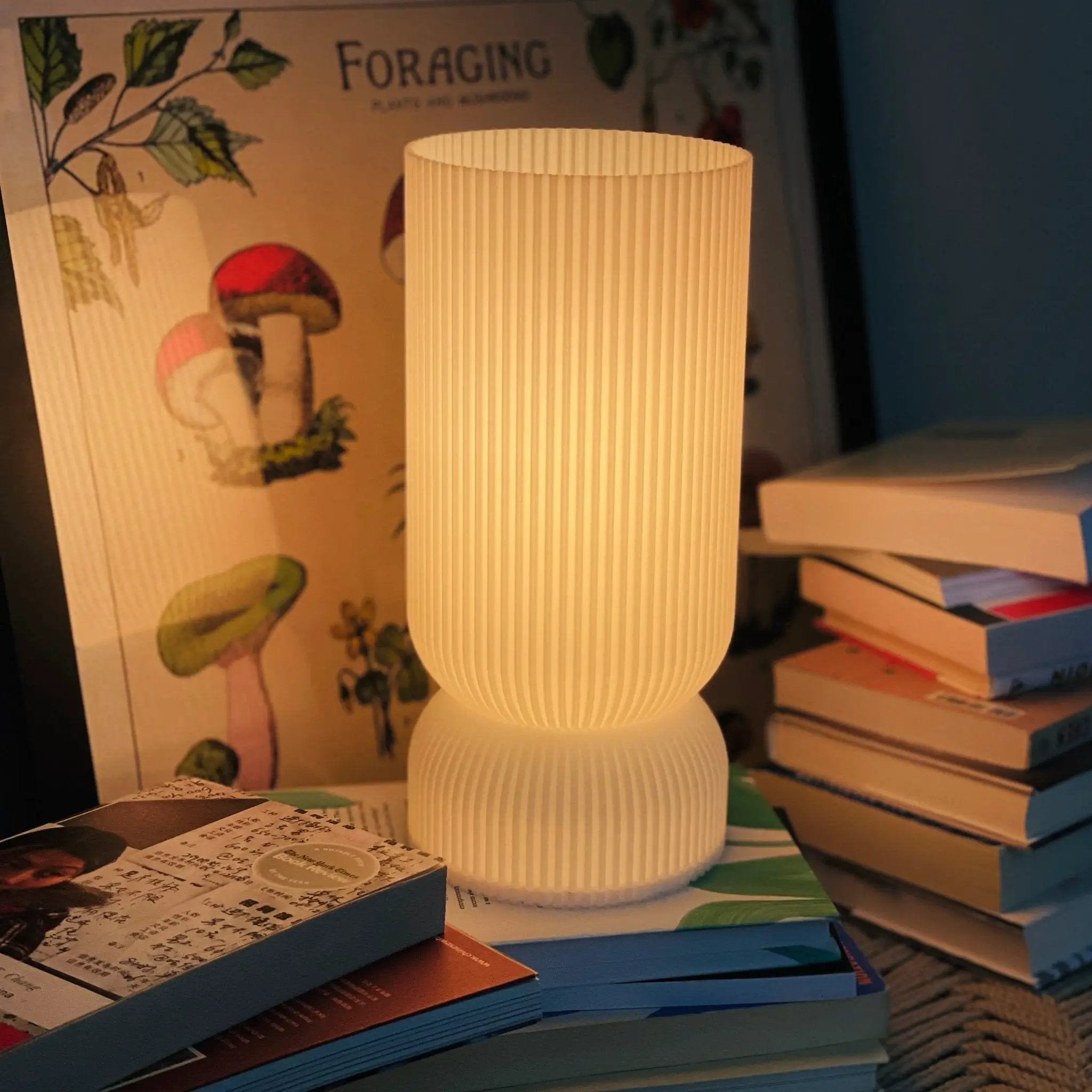 Stance Table Lamp by Terra Labs; white ribbed shade, warm glow.