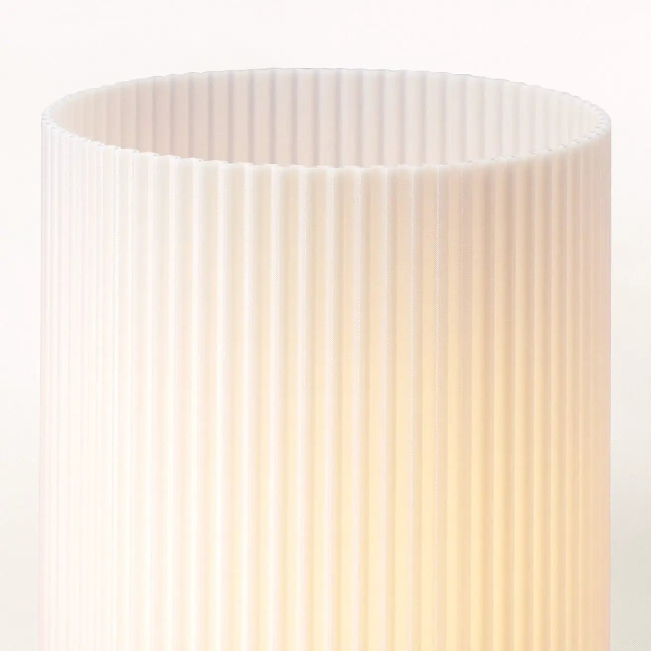 Stance table lamp with cream pleated fabric shade for ambient lighting