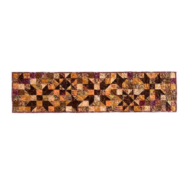 Quilt kit table runner with autumn star blocks; cotton precut pieces in orange, brown, and purple.