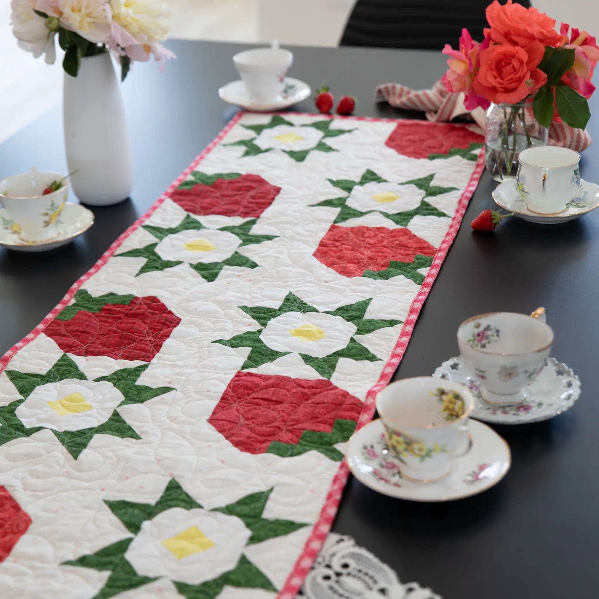 Strawberry Table Runner Pattern by Block Party Quilt Co; home decor sewing pattern in red, white and green floral colors.