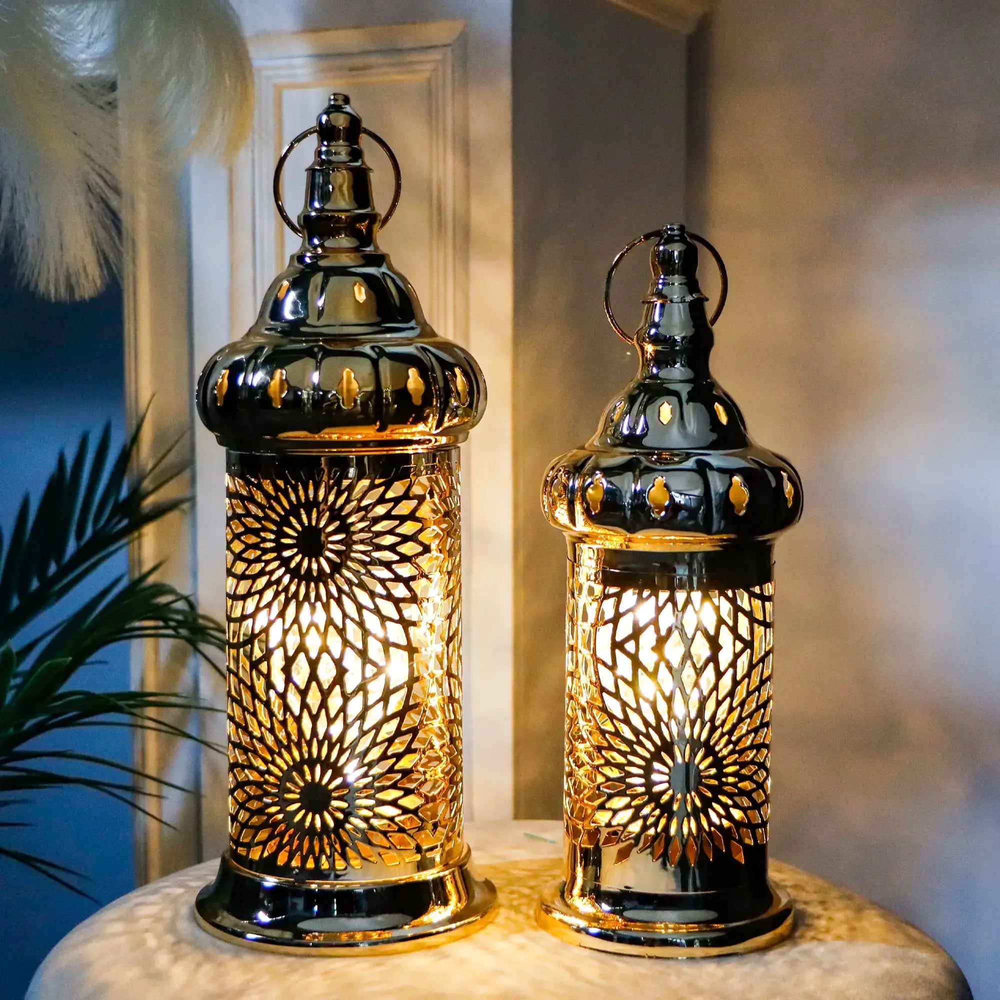 Set of 2 gold Ramadan lanterns with intricate lattice metalwork and warm LED candle light