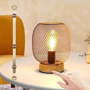 7.5''H touch-adjustable table lamp with wooden base and bronze wire cage, battery-powered