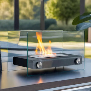 14-inch portable tabletop fireplace by JHY DESIGN with black body and clear glass surround, glowing flame.