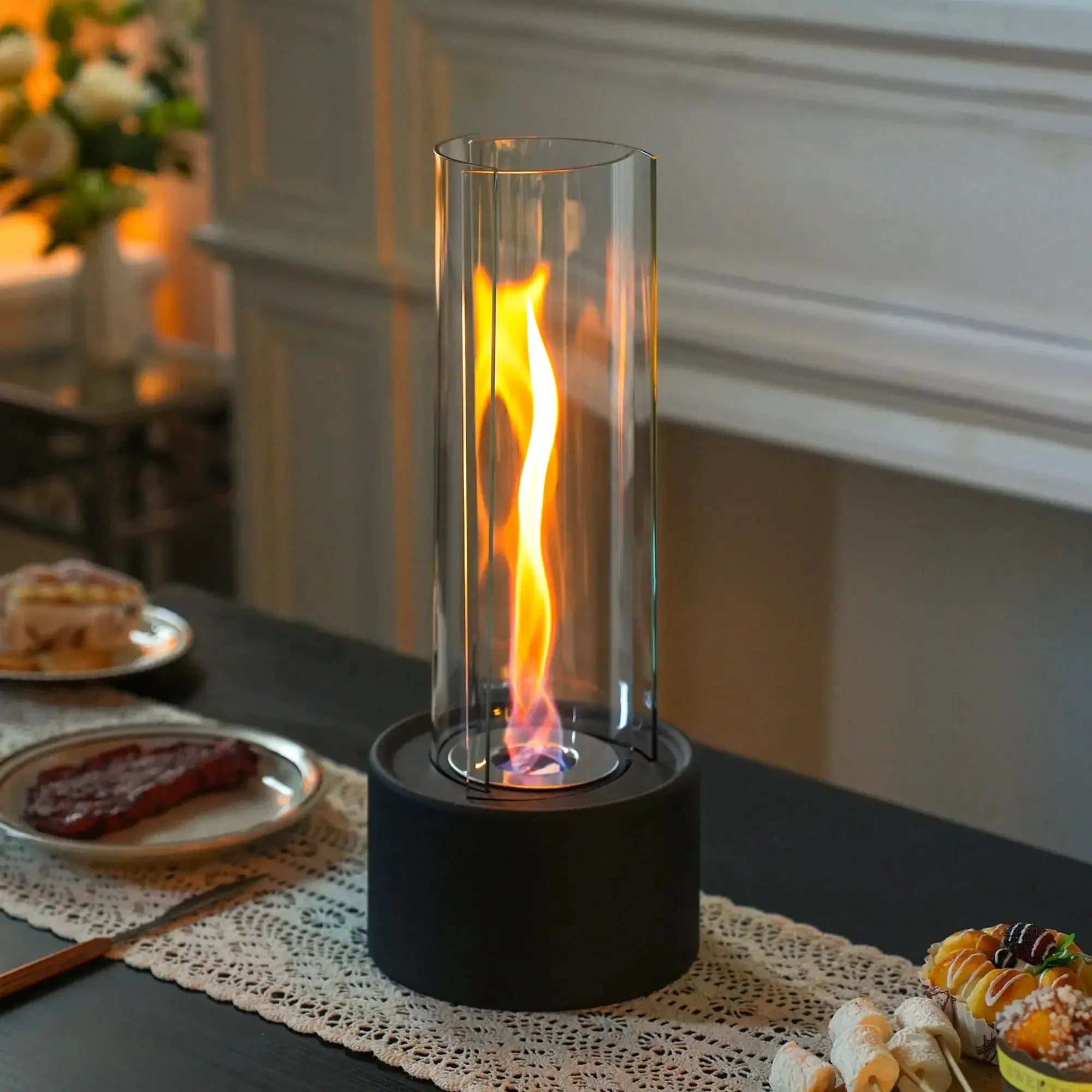Cylindrical bioethanol vented-free fireplace by JHY DESIGN; glass cylinder on black base for indoor use (16x16x39 cm)
