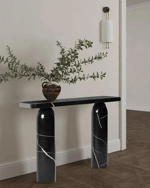 Toros black marble designer console with polished top and cylindrical veined legs