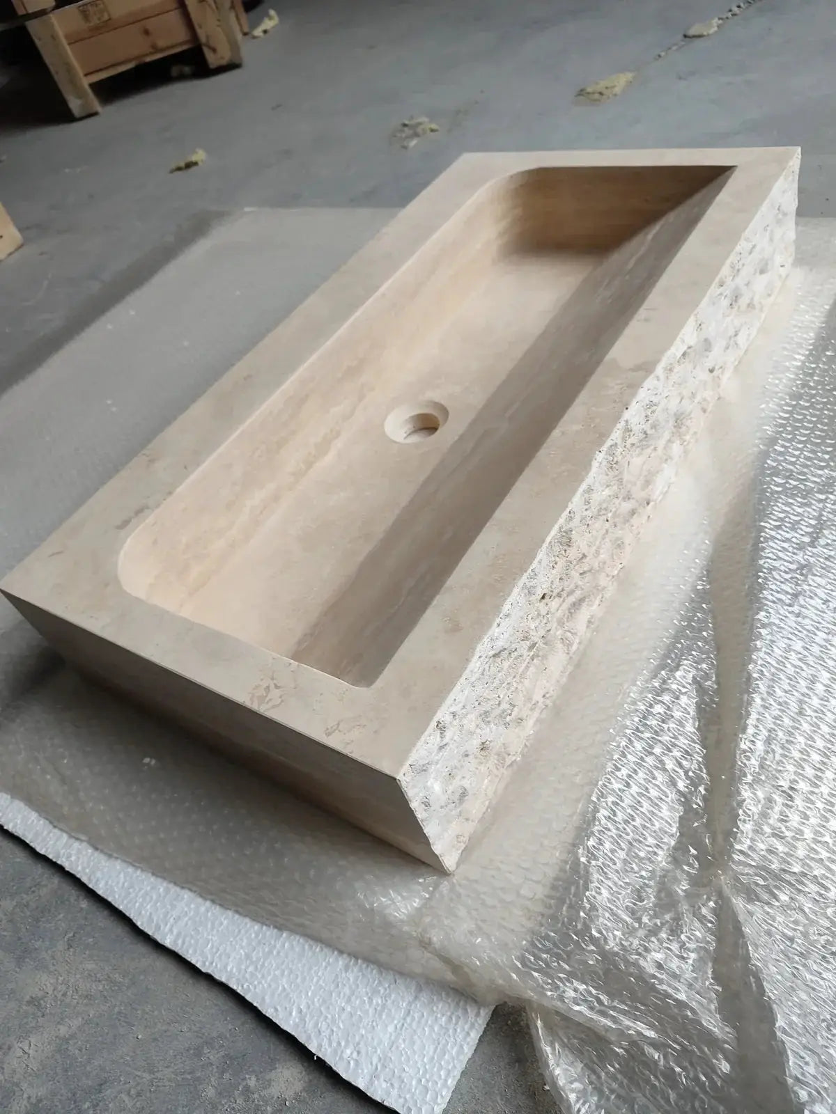 Troia light travertine rectangular wall-mount bathroom sink, beige stone with shallow basin and center drain.