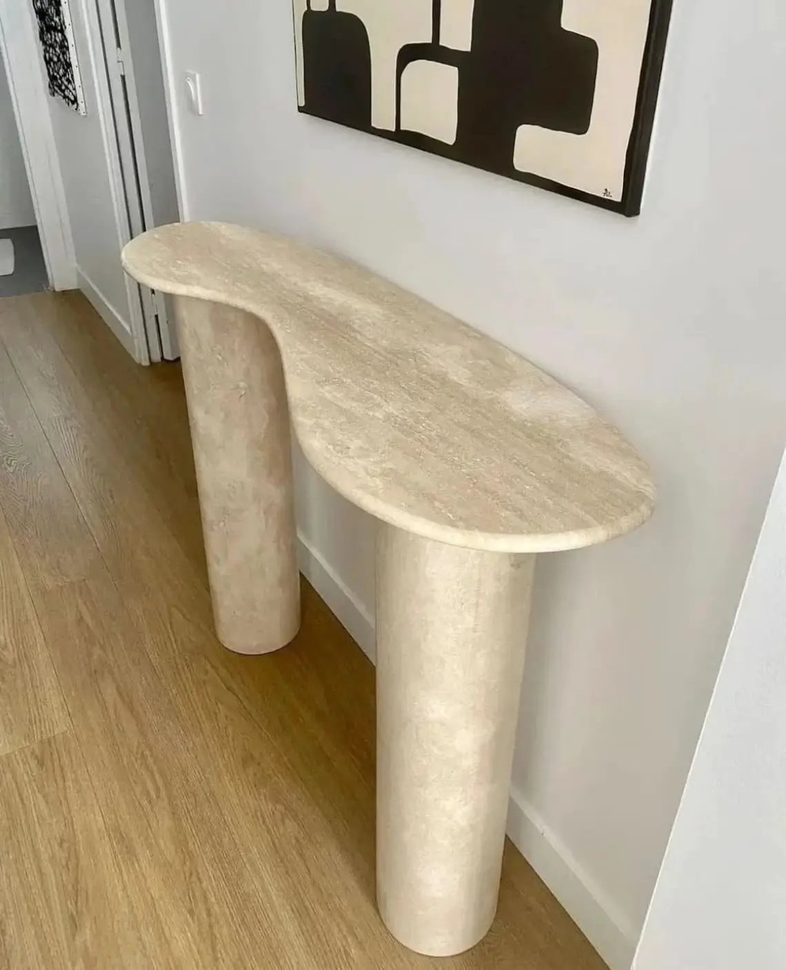 Troia Light Travertine Designer Console by Villohome; beige honed travertine with oval top and two cylindrical legs.