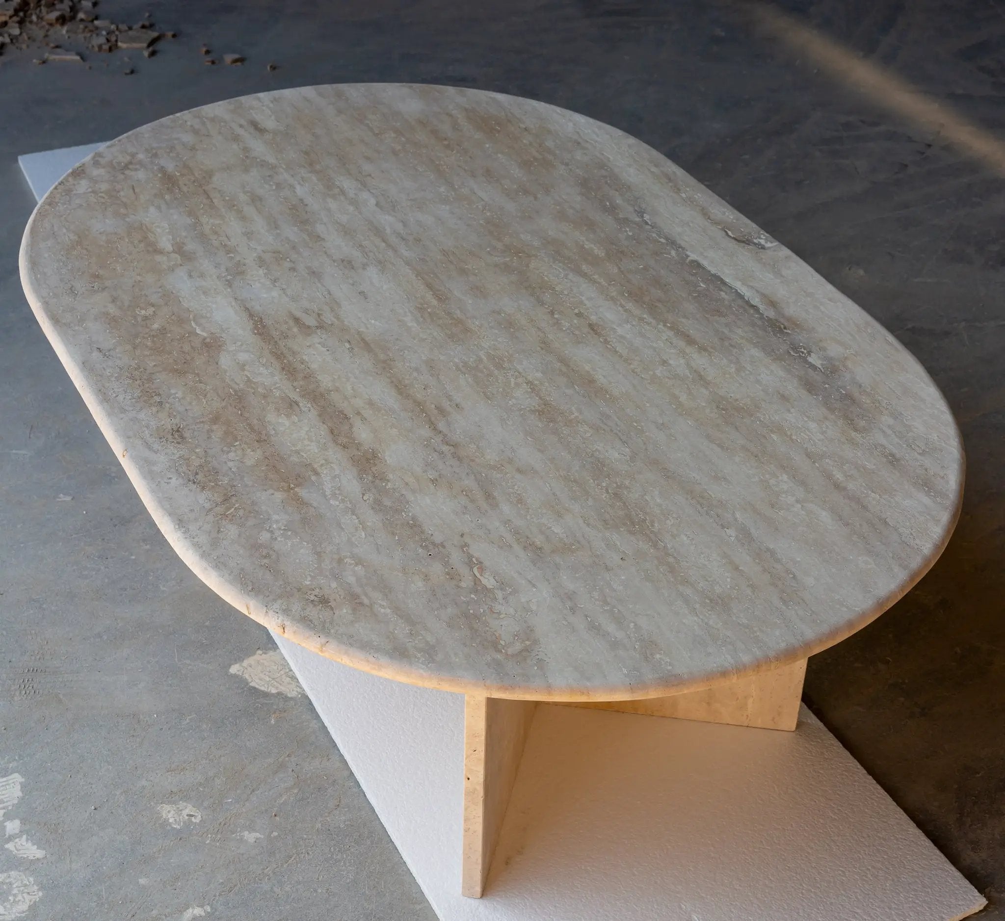 Troia light travertine oval coffee table with polished surface