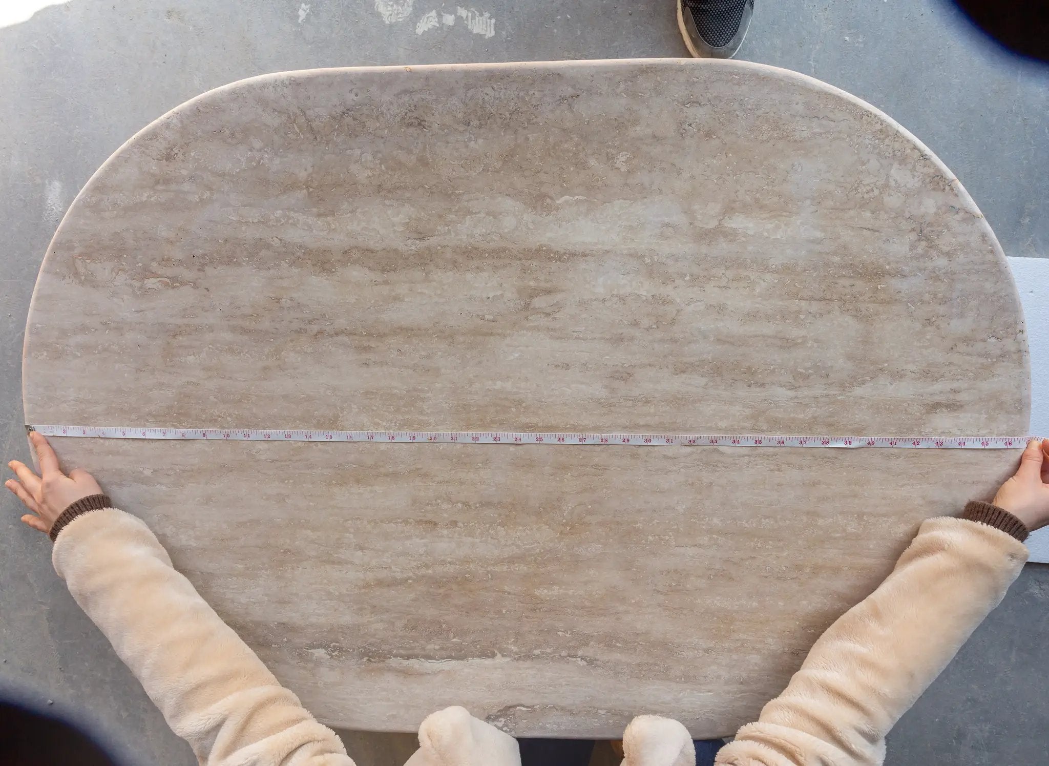 Troia Light Travertine oval coffee table, polished beige surface, 24W x 48L x 16H