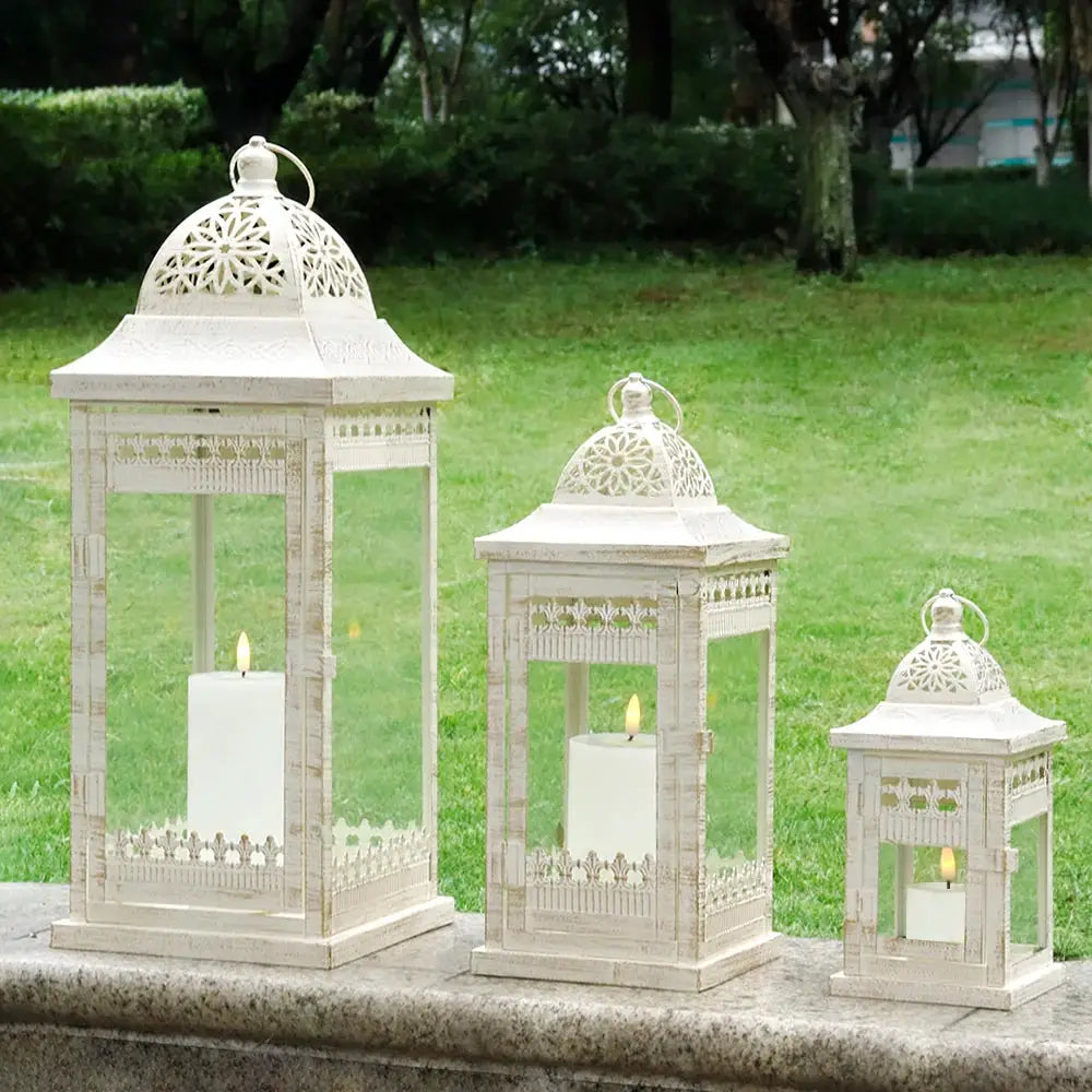 Set of 3 beige vintage metal decorative candle lanterns by JHY DESIGN; sizes 20in, 14.5in, 9.5in.