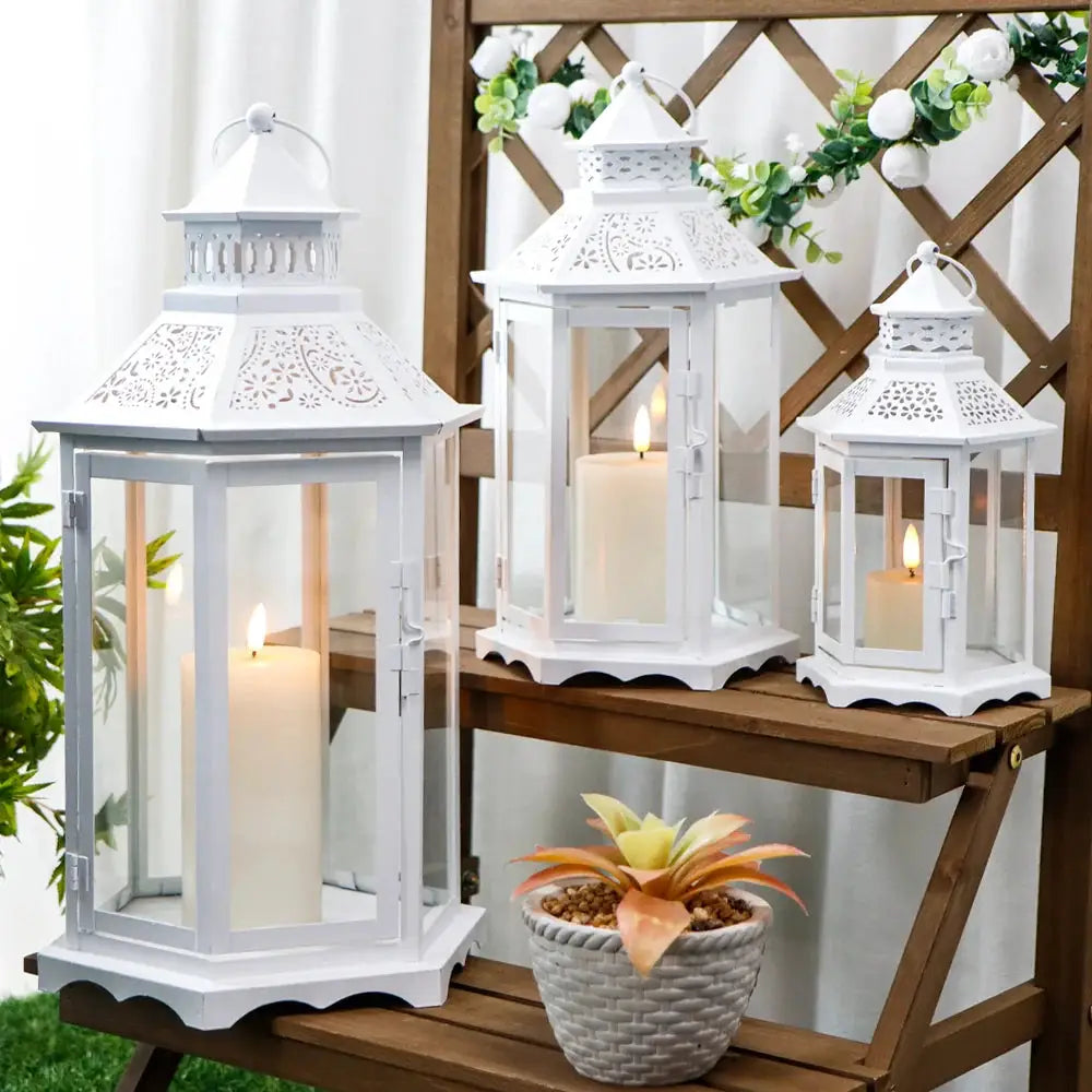 Set of 3 white hexagonal lanterns with glass panels and candles