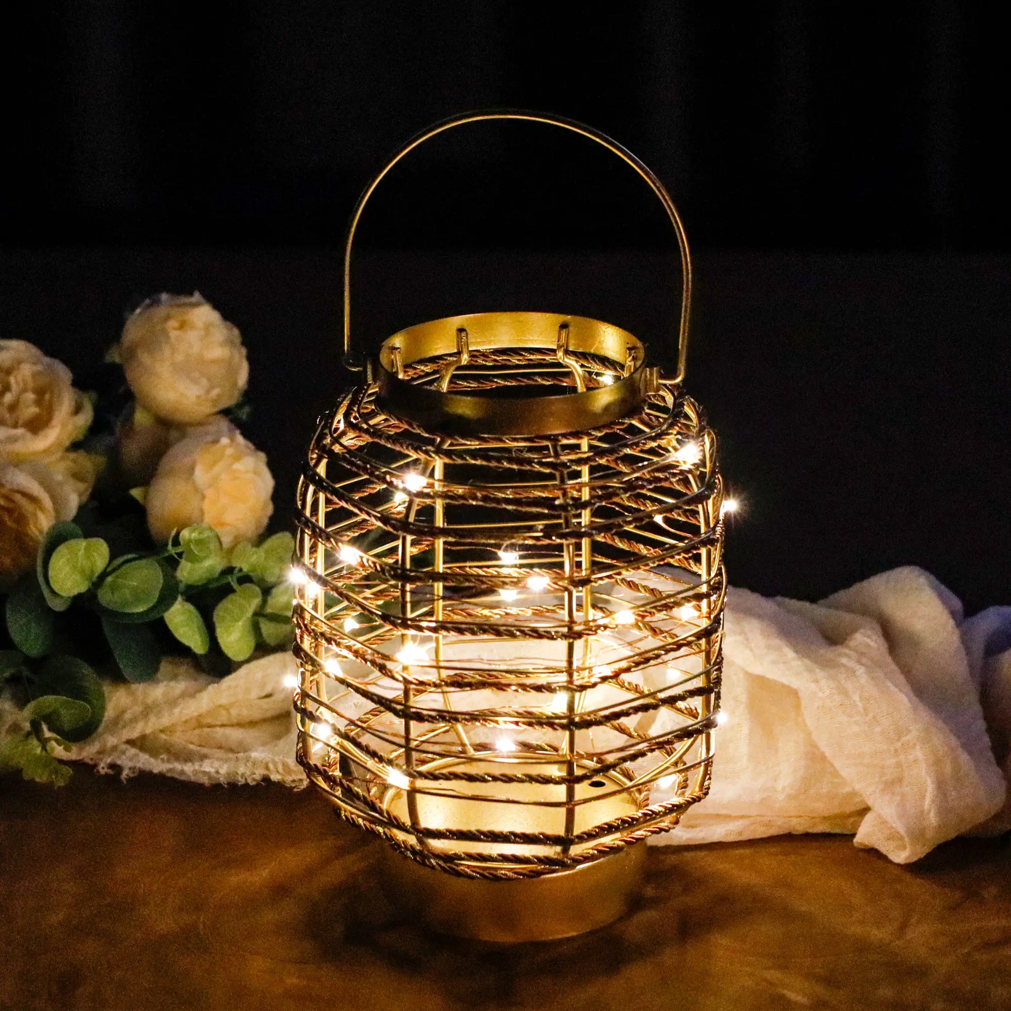 7.7-inch metal cage LED cordless table lamp, battery-operated, gold with warm string lights.