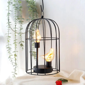 12-inch tall battery-operated birdcage lamp with two bird-shaped light bulbs inside; black metal cage by JHY DESIGN