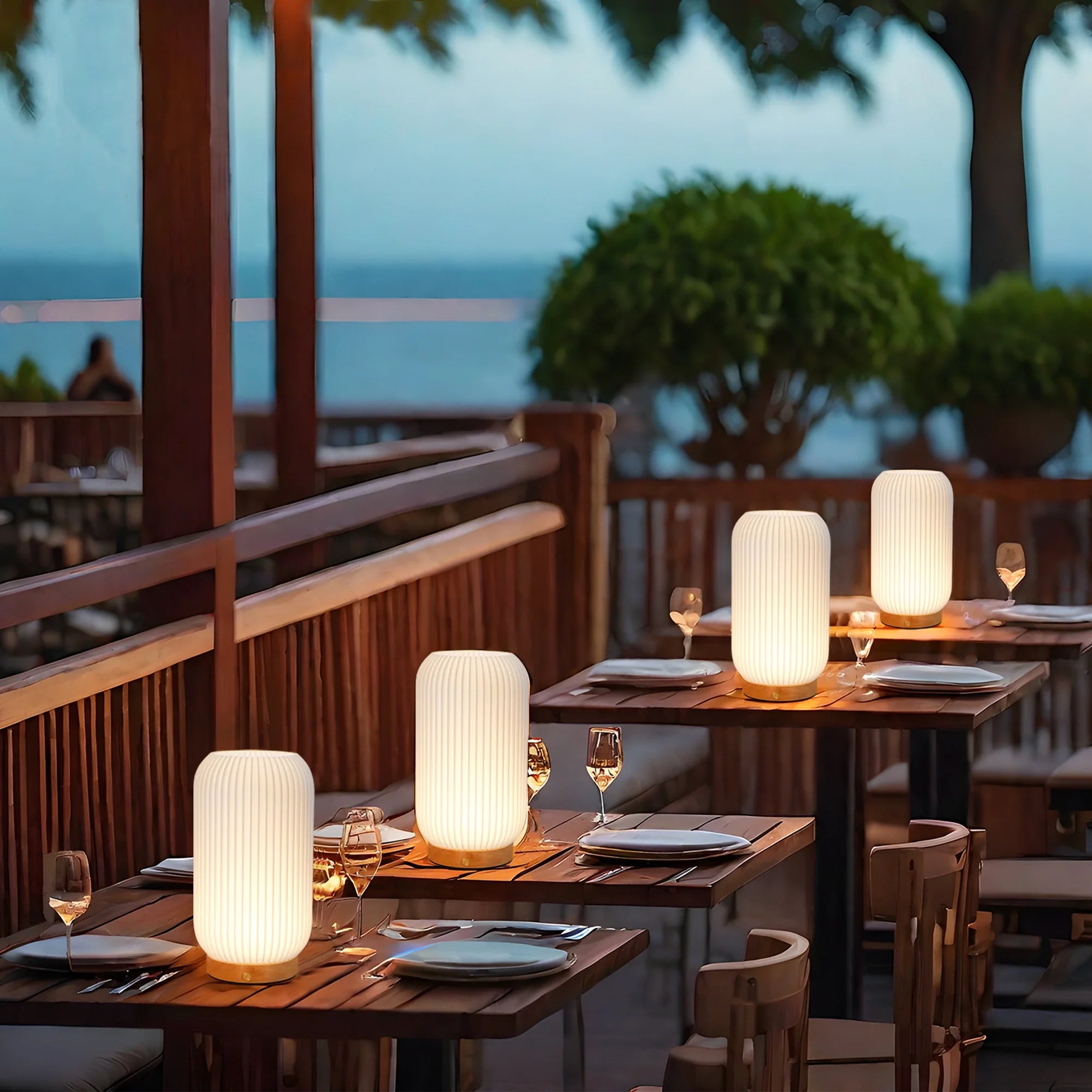 9 in rechargeable 3D-printed cylindrical lamp, white ribbed finish, shown on outdoor dining tables as several lamps.
