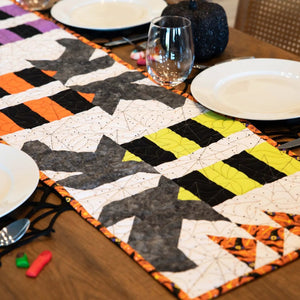 Witches Feet Table Runner Precut Quilt Kit by Block Party Quilt Co for Advent Calendars, orange, black, gray and white.