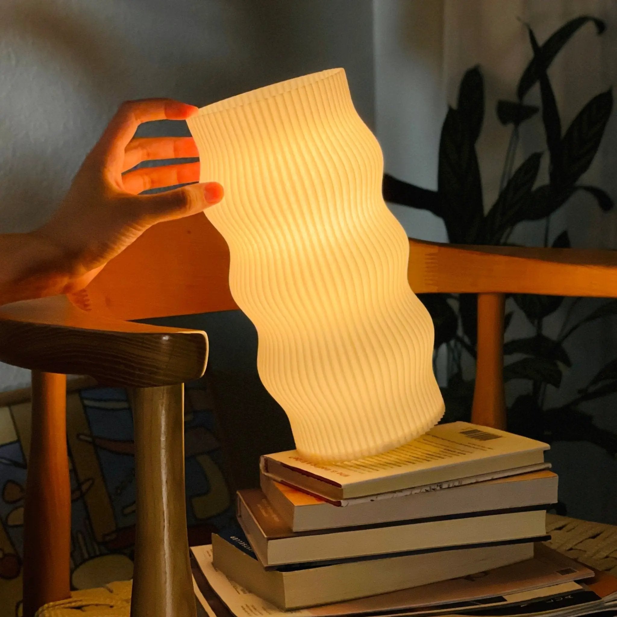 Wub table lamp with a cream ribbed curved shade, mimicking rolling clouds, warm glow