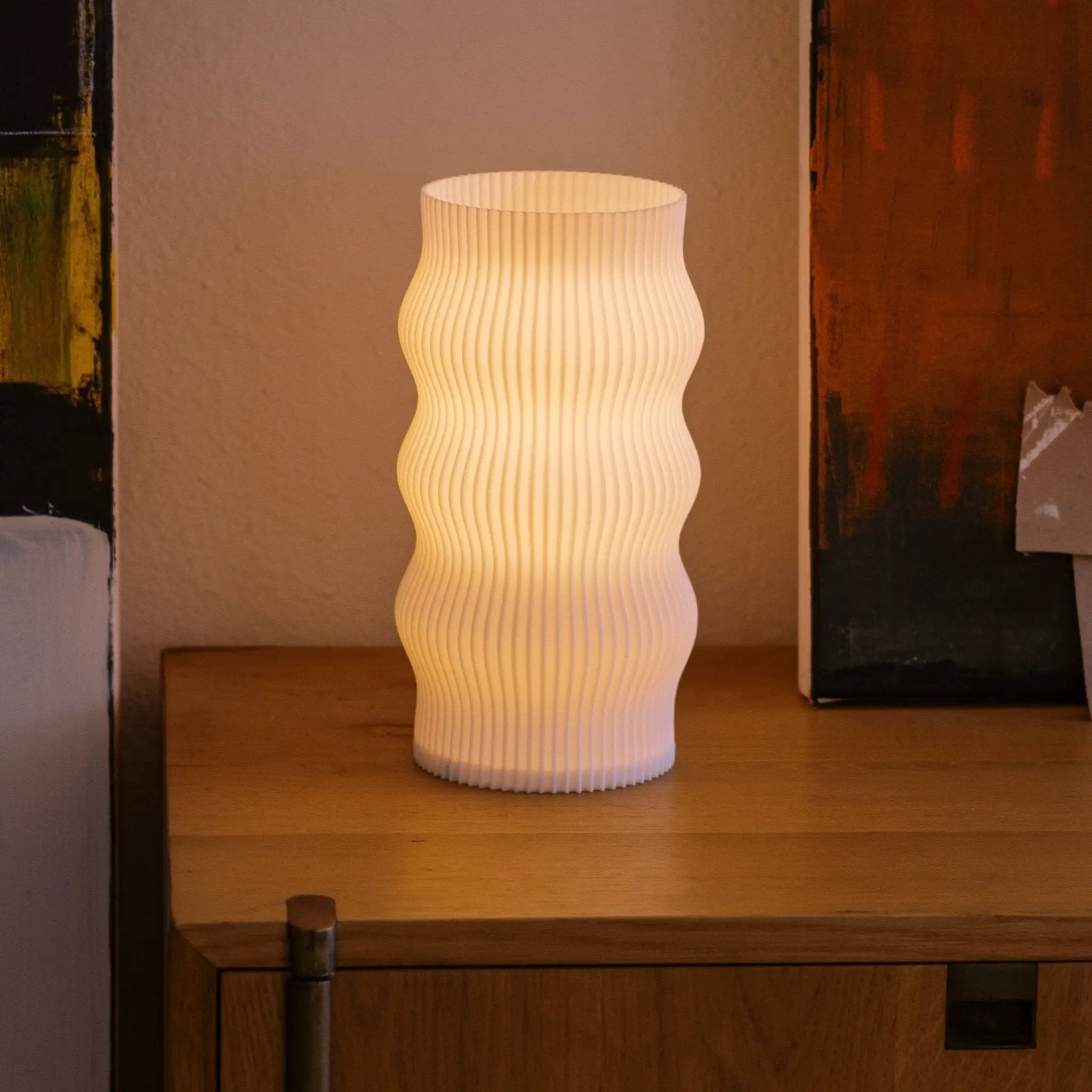 Wub Table Lamp featuring a white ribbed surface with cloud-like curves.