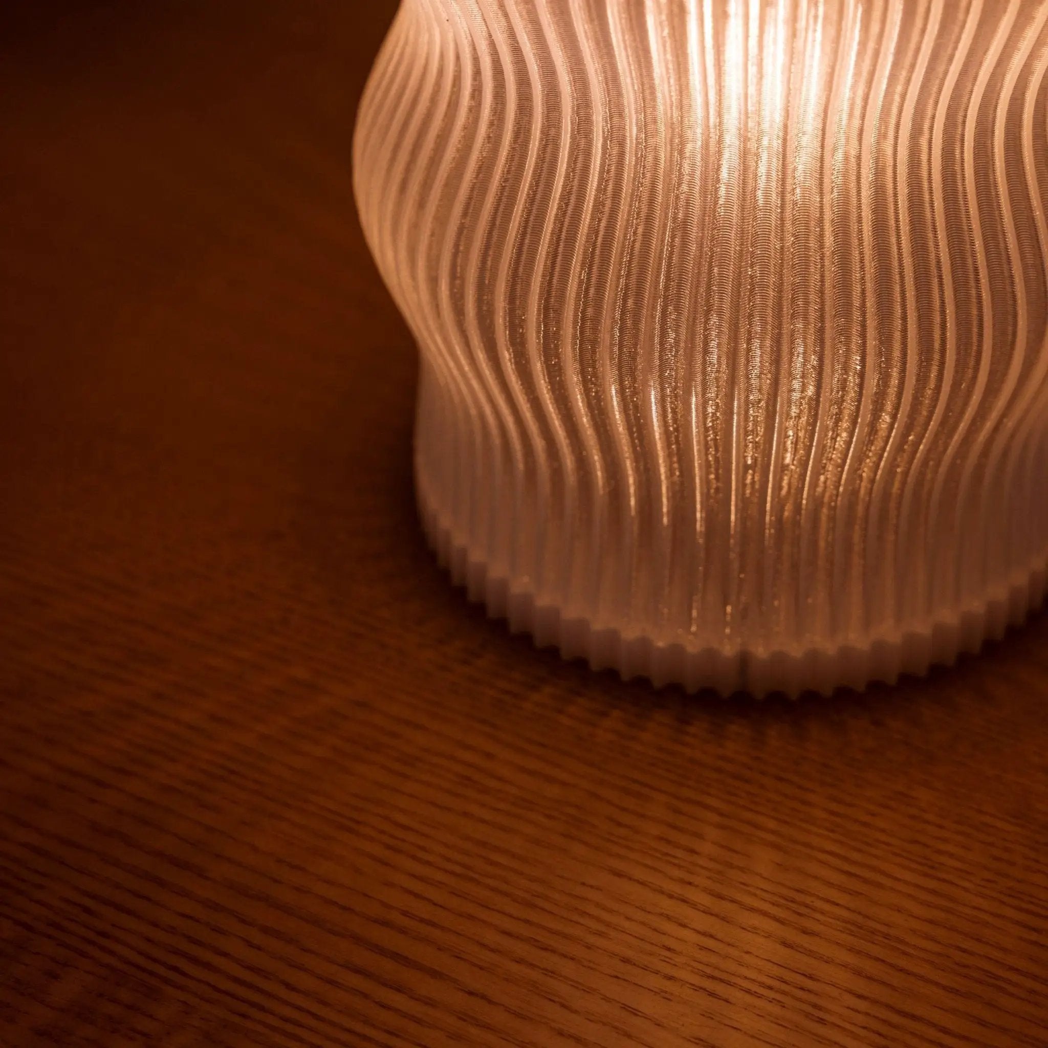 Yuji Table Lamp by Terra Labs with a ribbed warm-amber shade.
